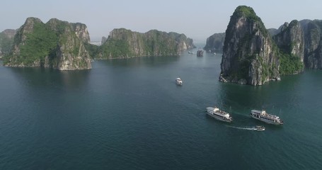 Wall Mural - Aerial view of royalty high quality free stock footage over natural rocks green tops Halong bay, Ba Hang floating fishing village, sea blue azure water. Wild natural untouched seascape. Asia, Vietnam