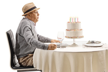 Sticker - Elderly man blowing candles on a cake