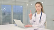 © stockbakers - Serious Young Female Doctor saying No by Finger in Office