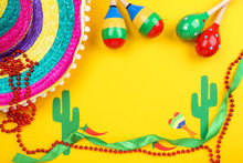 Mexican Hat With Maracas And Paper Cactuses On Yellow Background