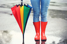 Woman Wearing Red Rubber Boots With Umbrella After Rain