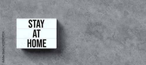 lightbox with text STAY AT HOME in front concrete wall Poster Mural XXL