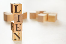 Four Wooden Cubes Arranged In Stack With Word LIEN On Them, Space For Text / Image At Down Right Corner