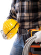 © francescomou - Electrician holds the roll of electric cable in his hand, helmet with protective goggles. Construction industry, electrical system. Isolated on a white background.