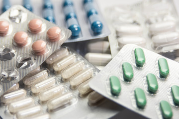 colourful pills tablets water packages and pill containers scattered on white clear isolated background