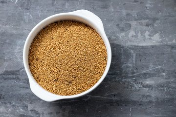 Poster - quinoa on white bowl on ceramic background