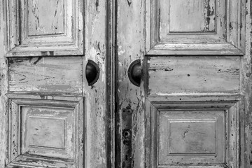 Wall Mural - Vintage old wooden door with cracks background texture, peeling paint retro design black and white