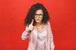 © denis_vermenko - Disappointed caucasian brunette woman, looking agressive isolated on red background in studio. People emotions, lifestyle concept.