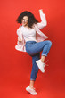 © denis_vermenko - Full length size dreamy charming cheerful leisure lifestyle student lady jumping isolated over red background wear in casual.