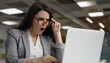Portrait of shocked business woman in stylish eyeglasses using laptop computer , looking at digital screen. Emotional female with open mouth watching breaking news on website about coronavirus