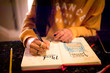 © Julia - Closeup of young teen girl writing in bullet journal on mood tracker page