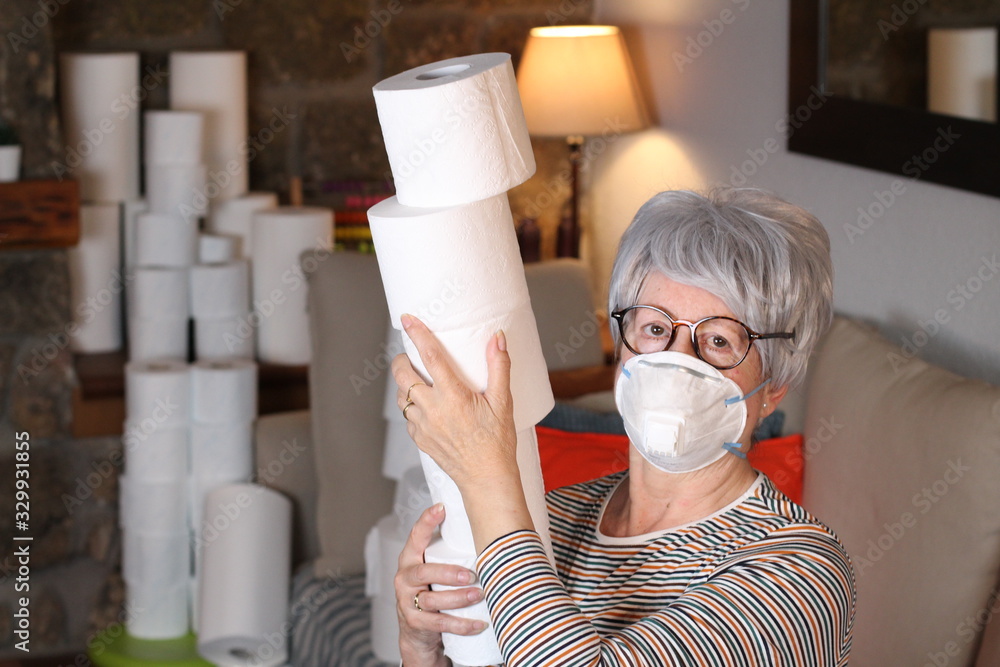 Senior woman stocking up toilet paper at home - obrazy, fototapety, plakaty 