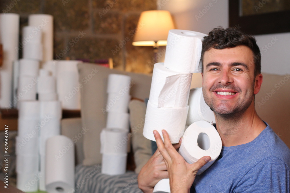 Man stocking up toilet paper at home - obrazy, fototapety, plakaty 