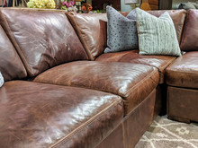 Close Up Of A Leather Sectional Covered With Pillows