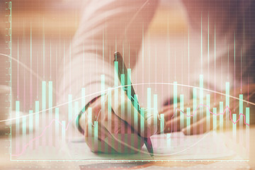 Financial trading chart multi exposure with man desktop background.