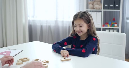 Poster - Speech therapist working with little girl in office