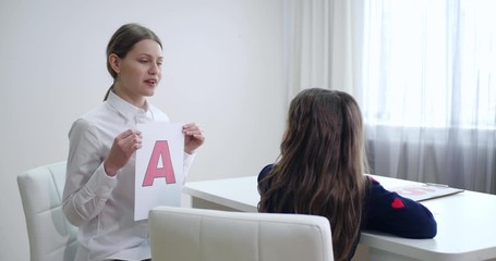 Sticker - Speech therapist working with little girl in office