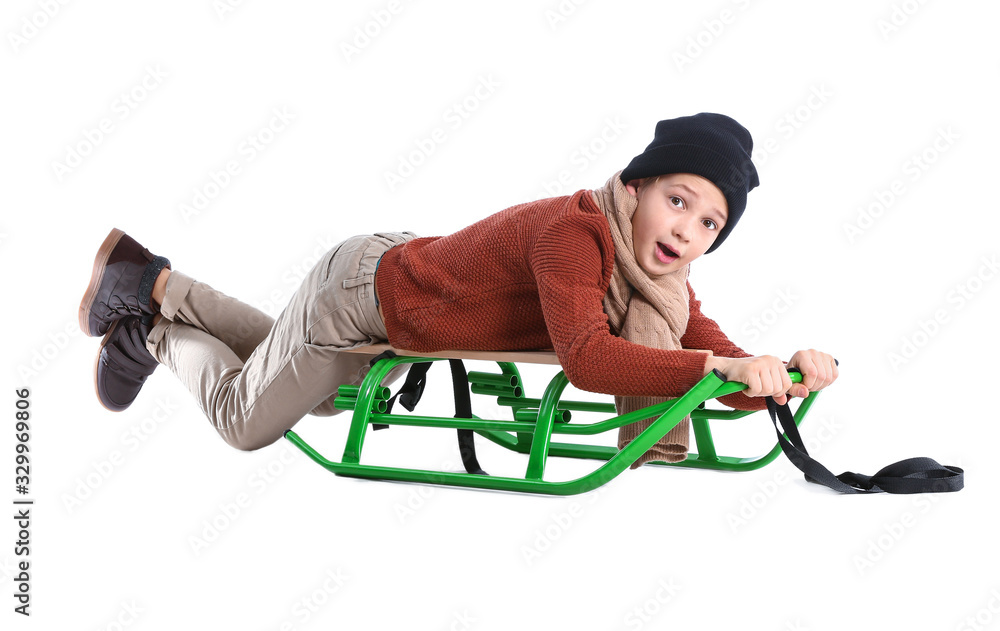Cute little boy in winter clothes and with sledge on white background