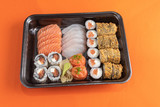 Fototapeta Storczyk - Delicious and beautiful sushi on the orange table