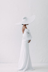 Minimalistic wedding series in European style. Stylish African bride. Concept and idea of a white wedding.