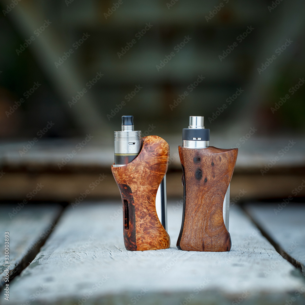 high end atomizer with stabilized natural wood regulated box mods, vaping  device, selective focus Stock Photo | Adobe Stock