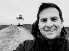 Portrait Of Smiling Mid Adult Man Against Lighthouse