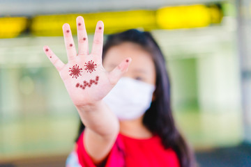 Wall Mural - Covid-19 and bacteria , Germs in hands concept.Little asian chinese girl showing dirty hands with virus covid19.Concept for wash hands first in Kids. Covid19 coronavirus and epidemic virus symptoms.