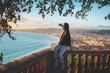 © Natallia - young female watching sunset in Nice, France. beautiful panoramic aerial cityscape top view of Nice, of French riviera. Landscape of harbor, town of Cote d'Azur France. woman enjoying evening