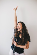 Young Beautiful Woman Sing In Vintage Microphone.