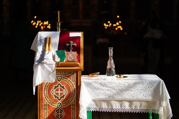 Poster - items for sacrament of baptism on table and ambo.