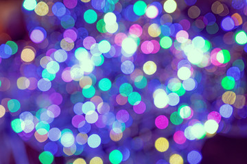 Christmas background. Festive elegant abstract background with colorful bokeh lights and stars