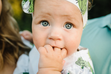 Baby close up. Young family spending time together on vacation, outdoors. The concept of summer holiday. Family look.