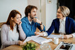 © Drazen - Happy couple and real estate agent having a meting at their home.