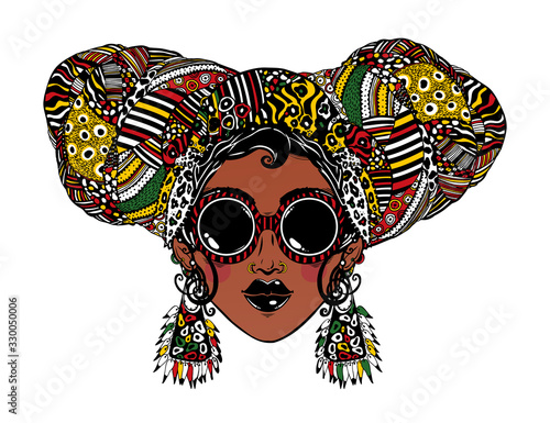 Fotografía Young urban fashionable beautiful woman in cool ethnic style with elegant geometric glasses, earrings and head wrap