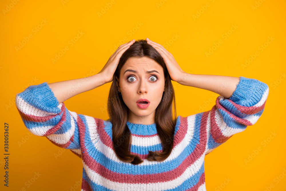 Closeup photo of attractive pretty lady open mouth listen awful terrible bad news unfair situation gold arms on head wear casual striped sweater isolated yellow color background - obrazy, fototapety, plakaty 