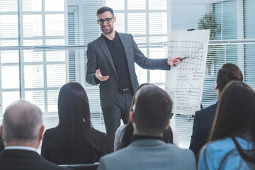 speaker is pointing at a flip chart during your business presentation