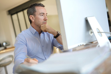 Wall Mural - Man in office working on desktop computer