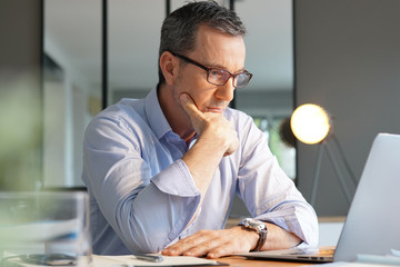 Wall Mural - Business manager working in office on laptop