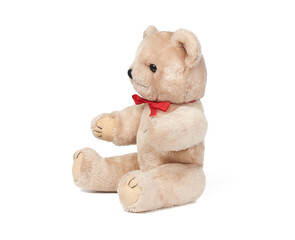 small brown teddy bear sits on a white isolated background