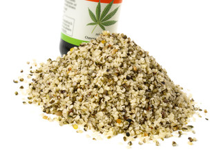 Wall Mural - Shelled Hemp Seeds with Hemp Oil Bottle isolated on white Background