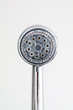 © Octavian - Silver round shower head with hard water deposits all around the sprinklers isolated against light grey backdrop