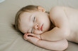 © kalinichenkod - Cute little baby sleeping on bed at home