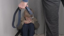 Child Abuse Concept. Father Beats Little Son With Domestic Violence Belt. Upset Punishment Boy Sits In Lifestyle The Corner Hand Swings To Hit
