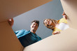 © stokkete - Happy couple opening a cardboard box and looking inside