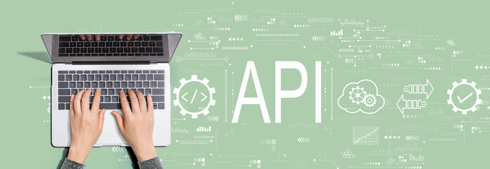 API - application programming interface concept with person using a laptop computer