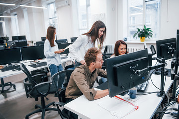 Group of young business people that working by computers in the modern office