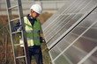 © hetmanstock2 - Engineer in a white helmet. Man near solar panel. Worker with a ladder
