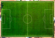 Aerial drone top view of mini football soccer field with playing people.