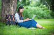 © tuiphotoengineer - beautiful Asian girl student holding books and smiling at camera and learning and education concept  on park in summer for relax time