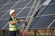 © hetmanstock2 - Engineer in a white helmet. Man near solar panel. Worker with a ladder